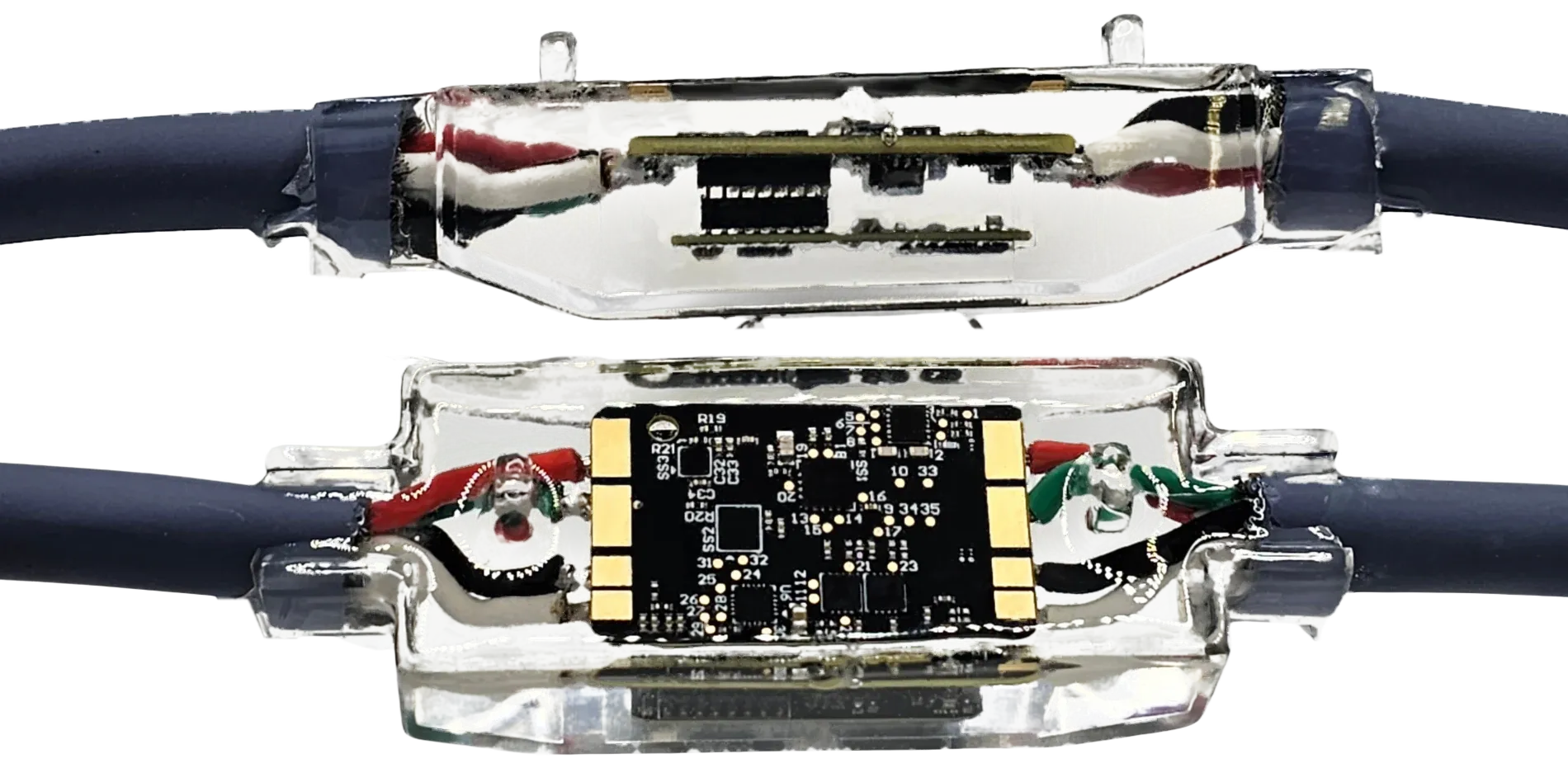 Two epoxy potted sensor nodes on the CAN bus cable, one showing the board inside